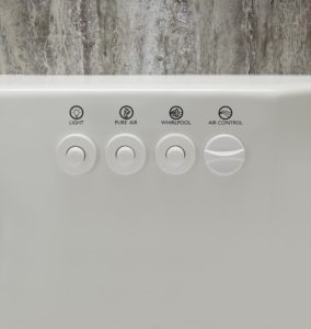 View of a Jacuzzi tub's three control buttons and a dial switch