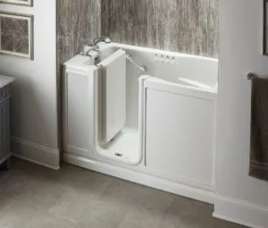 View of a white and gray stone bathroom, featuring a walk-in tub with the door opened