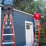 Rainbow Seamless Employees installing gutters