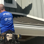 Rainbow Seamless employee installing gutters