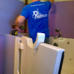A Rainbow Seamless Employee installing a walk in tub