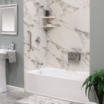 Silver Bathtub and Shower Fixtures with a gray marble bath wrap