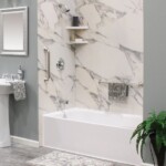 Silver Bathtub and Shower Fixtures with a gray marble bath wrap