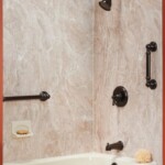 Brown Bathtub and Shower Fixtures with a cream marble bath wrap
