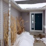 A lotus gutter chain with iced over water drainage