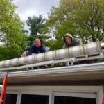 Rainbow Seamless Employees installing a motorized awning