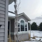 A lotus gutter chain with iced over water drainage